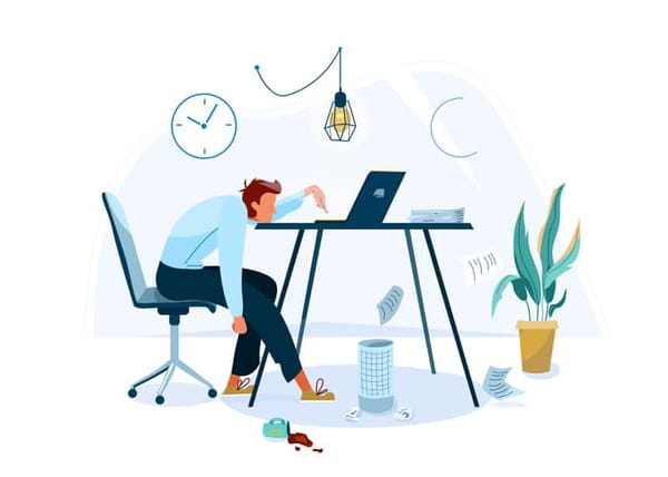 man at desk waiting for computer to load